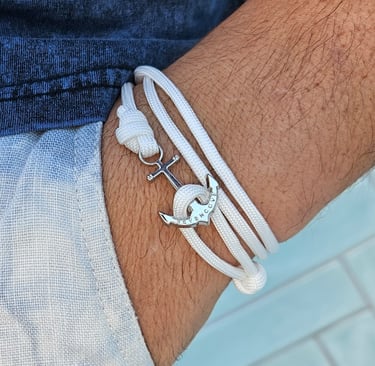 a man's armbands with a anchor on it