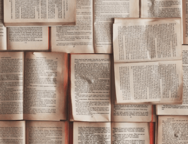 Pile of old used books open to read