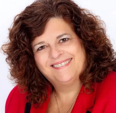 Professional headshot of Laura Cohen, Esquire smiling and wearing a red blazer.