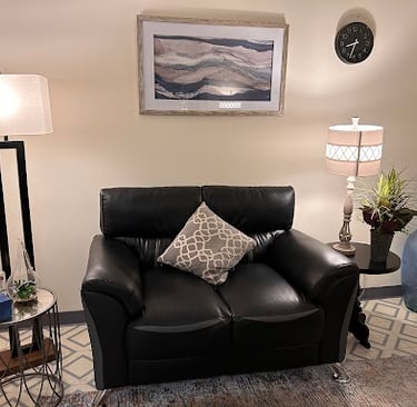 Sunrise Counseling Center Babylon Office room with a black couch