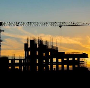 a crane is seen at sunset in this photo