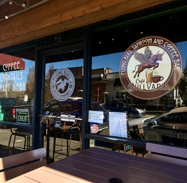 Storefront of Flying Bull Taproom and Coffee Bar with cafe seating and neon signs for craft beer and cocktails.
