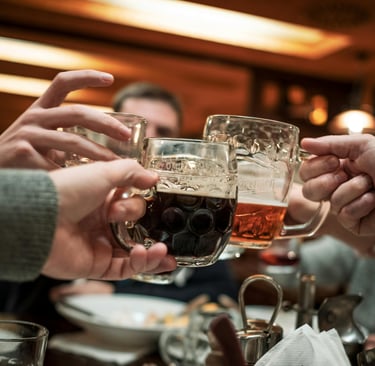 Beer mugs raised in a toast