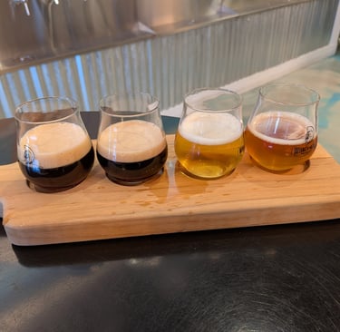 a wooden flight holder with glasses of beer