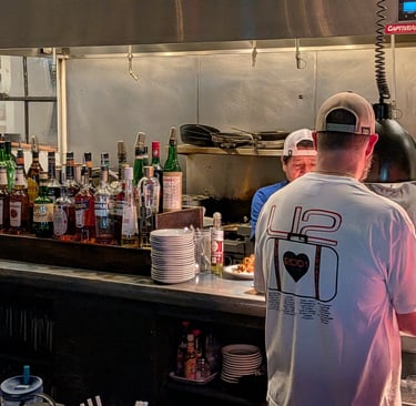 kitchen with chefs and waiter