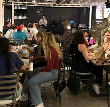 a group of people sitting at a table with drinks