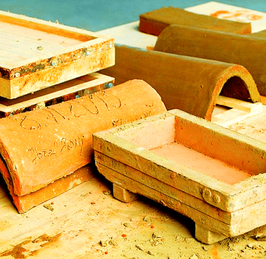 Traditional wooden brick moulds used for shaping handmade clay tiles, made from seasoned hardwood an