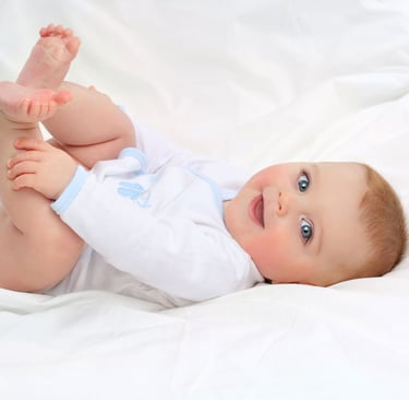 Smiling baby in organic babygrow