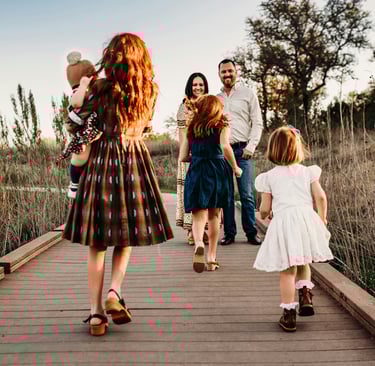 a family walking across a bridge with their children