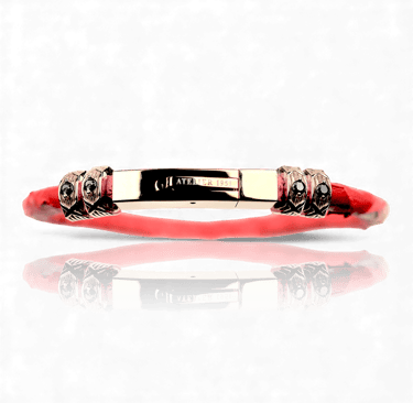 Luxury red band bracelet with gold hardware and black gemstone accents from Atelier 1951.