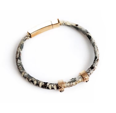 Luxury snakeskin leather bracelet with gold magnetic clasp and skull charms for men.