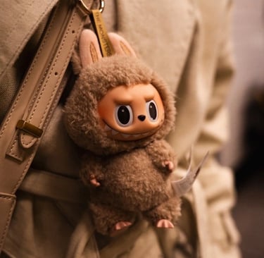 Labubu plush keychain handing from a backpack