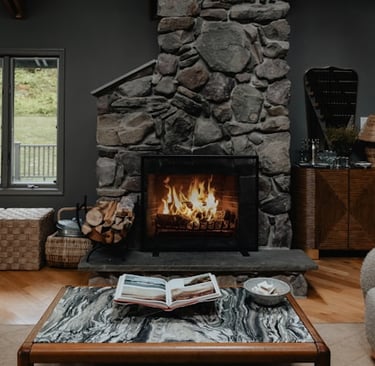 a living room with a fireplace and a stone fireplace