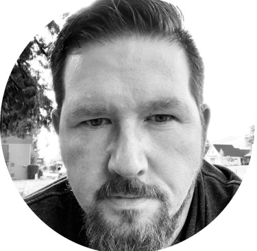 A circular, portrait photograph in black-and-white of Jason Roy, founder of SiteLine Services