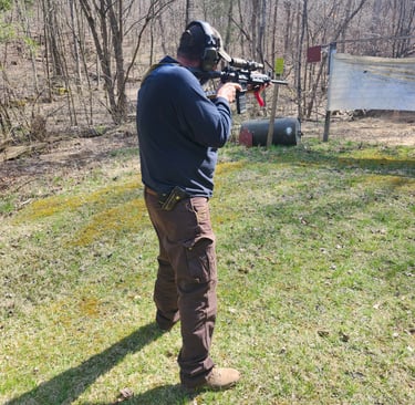 Man using self-defense firearm on range.