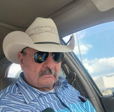 a man in a cowboy hat and sunglasses
