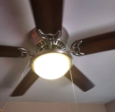 a ceiling fan with a light on top of it