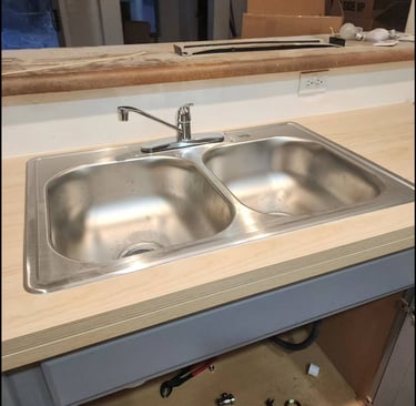 a kitchen sink with a sink and a counter top