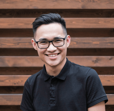 a man in a black shirt and glasses