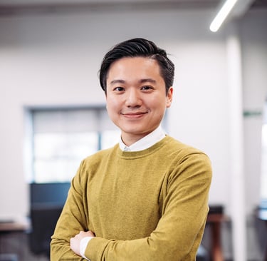 a man in a yellow sweater and a white shirt