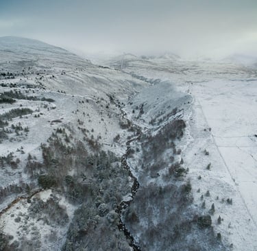Aerial view of snow in the mountains of Cairgorms National Park in Scotland