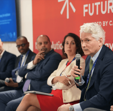 COP climate conference event with speakers giving presentation.