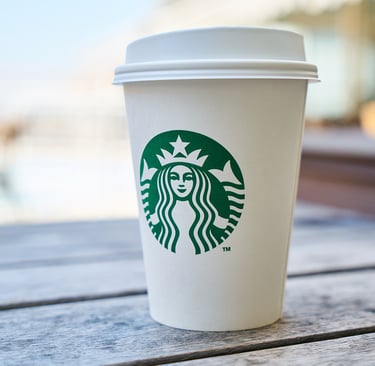 a starbucks cup on a wood table