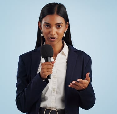a woman in a suit is holding a microphone