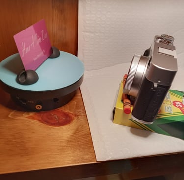 Using dollar store crayons as a tripod to take a photo of the metal card