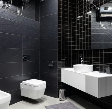 Modern bathroom display of premium sanitaryware items including wash basin, toilet, and faucet at Gulf Ceramics showroom