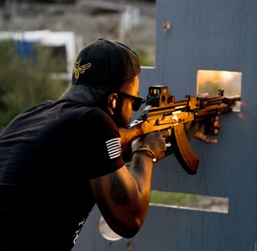a man is at the range holding a AK 47