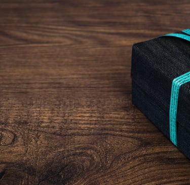 black gift box with a green ribbon