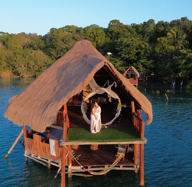 a couple standing on a dock in the water