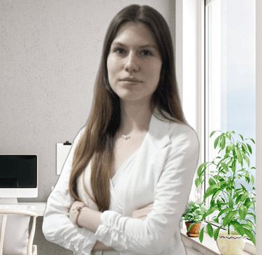 a woman in a white shirt and jeans standing in front of a computer