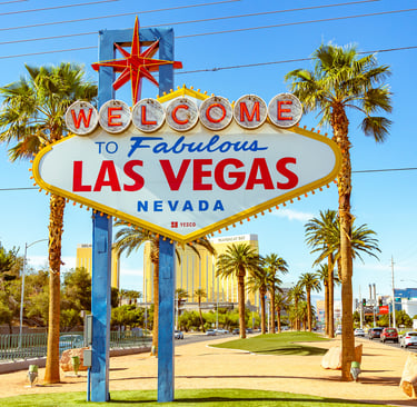 The iconic Welcome to Fabulous Las Vegas sign on the Las Vegas Strip surrounded by palm trees.