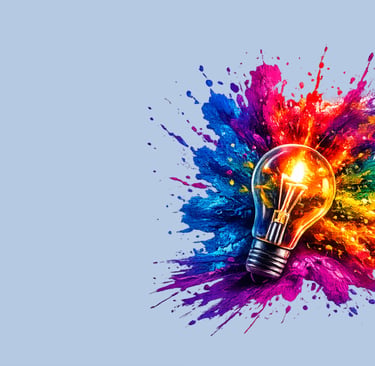 A glowing light bulb surrounded by vibrant colorful paint splashes, symbolizing creative ideas and innovation.