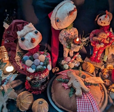 a group of rustic christmas decorations including a primitive santa clause and snowman