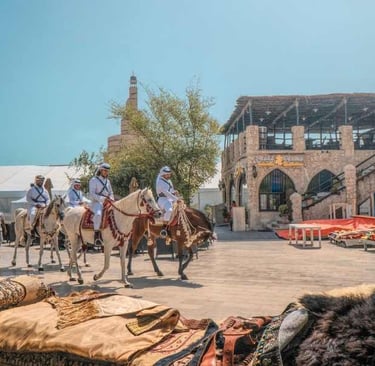 a group of people riding horses in a town