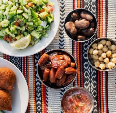 a table with plates of food and a bowl of food