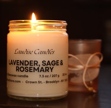 A lit candle. Lavender, Sage and Rosemary - 9oz jar