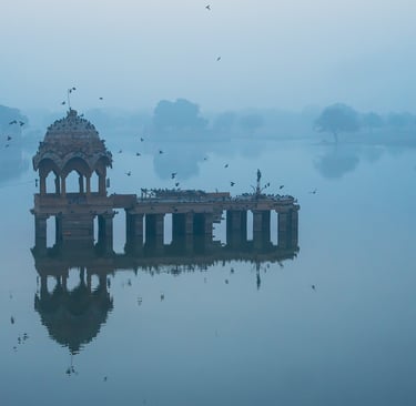 Sunrise reflections at Gadisar Lake in Jaisalmer.