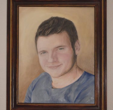 a framed oil painting portrait of a young man in a blue shirt