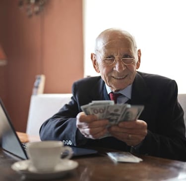 retired individual holding money symbolizing his retirement savings and wealth