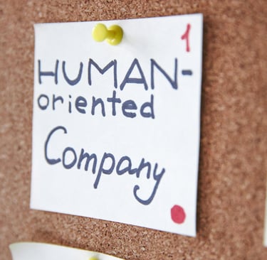 Post on wall saying human oriented company representing augusta precious metals having good values