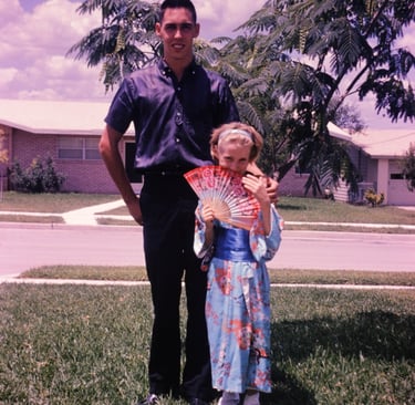 Vintage photograph of a young Art Rainbolt standing beside his little sister who is wearing a kimono