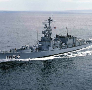 The USS Bridget (DE-1024), a U.S. Navy destroyer escort, underway at sea with white water trailing.