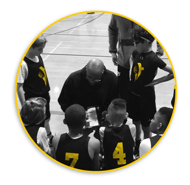 Pic of Infinite Training AAU Basketball Team in huddle with coach Joell Crawford