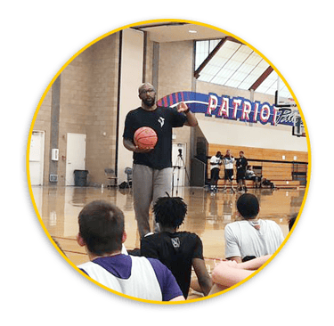 Pic of Coach Joell Crawford in front of basketball athletes