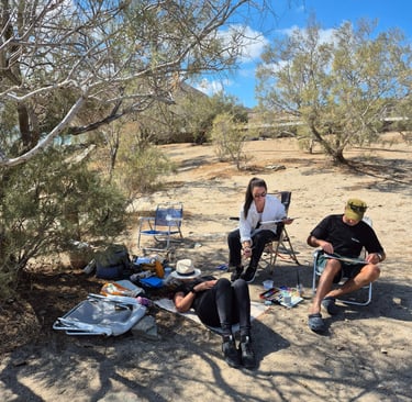a group of people painting under the trees