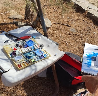 a watercolor pallett and other painting materials